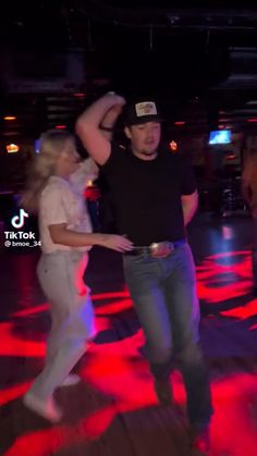 two people are dancing on the dance floor