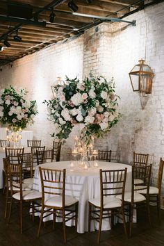 the tables are set with white and pink flowers