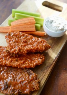 meat patties with carrots, celery and dip on a cutting board