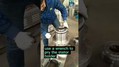 a man is working on a machine in a factory with the words use a wrench to pry the stator holder