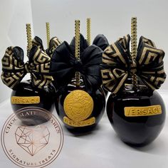 three black and gold ornaments are sitting on a table