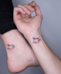 two people with matching tattoos on their legs