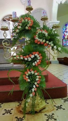 an arrangement of flowers is on display in the church