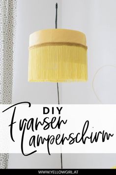 a yellow lamp with the words diy lampshade in black and white above it