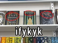 there are many books on the shelves with red marks in front of them and one has an upside down caption that reads ifykk