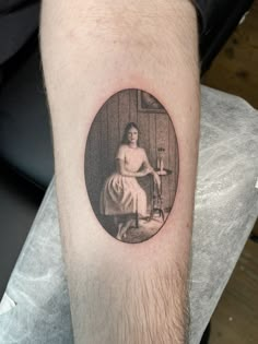 a man's arm with a portrait tattoo on it