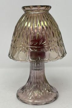 a glass lamp that is on top of a table