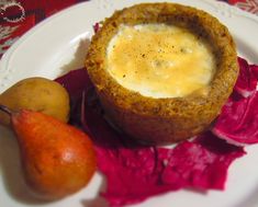 a white plate topped with food next to a pear