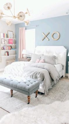 a bedroom with blue walls and white furniture