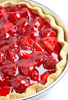 a pie that has some strawberries on it and is ready to be baked in the oven