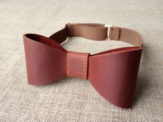 "Brown color leather Bow tie. ►Bow tie made of mat genuine cowhide leather (calf leather) with a waxy coating. ►It is a unique accessory to have a perfect outfit on the wedding, entertainment or in the everyday life. ►You can personalized this bow-tie with name, date, initials or personal logo and it could become a perfect gift. Please, let me know which Name, Initials or Date would you like by selection Menu and add all necessary information to the window \"Personalization\" or to the \"Note To Adjustable Detachable Bow Tie As Gift, Dapper Bow Tie With Detachable Bow As Gift, Dapper Brown Bow Tie For Wedding, Dapper Detachable Bow Tie As Gift, Brown Bow Tie For Father's Day Gift, Adjustable Brown Bow Tie For Business, Dapper Brown Bow Tie With Tie Back, Father's Day Brown Formal Bow Tie, Red Bow Tie Adjustable For Gift