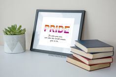 some books and a potted plant are sitting on a shelf next to a framed print