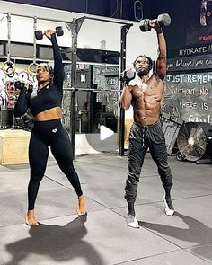 a man and woman doing exercises with dumbbells in front of a gym wall