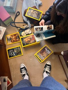 a person sitting on the floor with some books