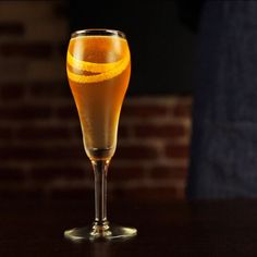 a glass filled with liquid sitting on top of a table