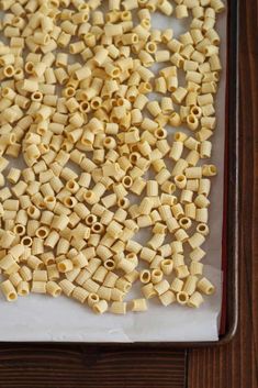 some pasta is sitting on a pan and ready to be put in the oven for cooking