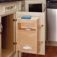 an open cabinet in the middle of a kitchen