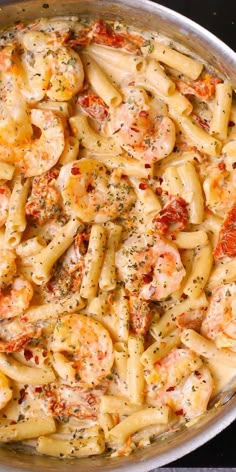 a pan filled with pasta covered in shrimp and sauce