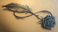 a black rose with a feather on it's side and an arrow in the middle