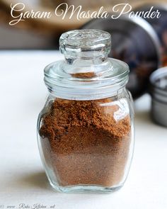 a glass jar filled with brown powder on top of a table