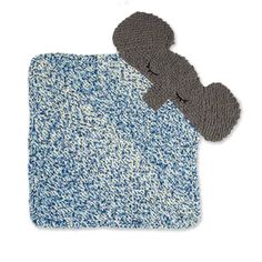 a blue and white rug with a gray teddy bear on the bottom, next to it