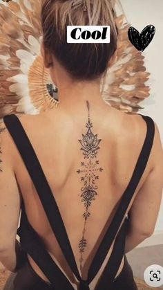 the back of a woman's neck with tattoos on it