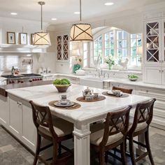 a large kitchen with an island in the middle