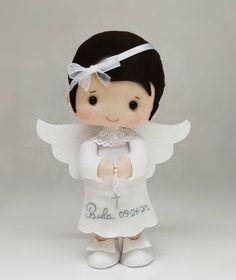 a little angel doll with white wings and a name on it