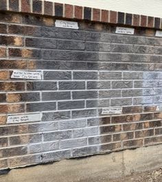 a brick wall with some writing on it