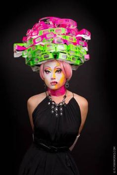 a woman with bright makeup and colorful hair is wearing a hat made out of plastic cups