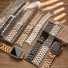 several different types of watches sitting on top of a wooden table