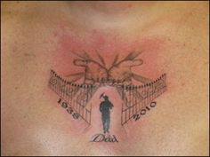 a man with a tattoo on his chest that says dad and two hands holding the gate