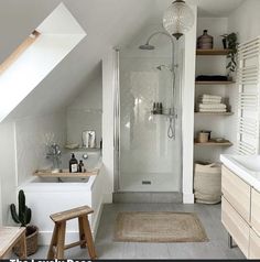 an attic bathroom with white walls and flooring