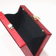 Introducing the Red Box Acrylic Clutch —a beautifully enchanting statement piece perfect for your next special occasion. Crafted from luxurious red pearlescent acrylic, this one-shoulder banquet clutch adds a touch of elegance to any ensemble. Its horizontal square box shape provides a structured, yet graceful design, complete with a secure top button closure. The soft lining ensures durability, while the option to carry it as a clutch or add a chain strap offers versatile styling. This beautifully crafted clutch is the perfect way to enchant your evening and elevate your look with effortless beauty. Minimalist Clutch, Acrylic Box Clutch, Prom Clutch, Red Luxury, Acrylic Bag, Acrylic Clutch, Luxury Party, Pvc Fabric, Ladies Clutch