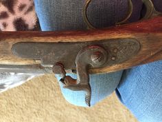 an old wooden handle on a chair with blue jeans