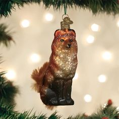 an ornament shaped like a fox hanging from a christmas tree