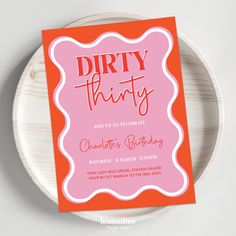 an orange and pink birthday party card on a plate with the words dirty thirty written in red