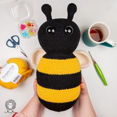 a crocheted stuffed bee sitting on top of a table