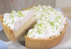 a white plate topped with a cake covered in frosting and green sprinkles