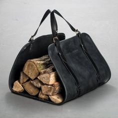 a black leather bag with logs in it