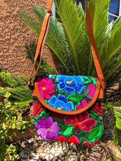 *Please advise each bag has a different design and color. If you want a specific design please message us for photos* The vibrant embroidered flowers that are carefully crafted by artisans in Mexico bring such beauty to this bag. You can style this as a shoulder or crossbody bag for any occasion. Measurements: 10 inches (width) x 9 (length) Made with suede Adjustable straps Snap closure pocket Front and back pockets Las vibrantes flores bordadas que son cuidadosamente elaboradas por artesanos en Mexican Bag, Embroidered Purse, Floral Purse, Floral Bags, Boho Purses, Crossbody Bag Women, Hippie Style, Embroidered Flowers, Colorful Flowers