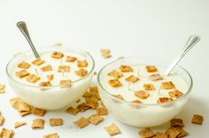 two bowls filled with cereal sitting on top of a table