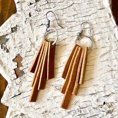 These hand-crafted Tan Leather Strip earrings are the perfect accessory to dress up or down your outfit! Strips of real leather are handcut,  pierced and attached to a silver-tone hoop. This design is eye-catching, yet understated with its simplicity. Length of finished earring is about 2 inches. Attached to silver-toned French style fish hook that allows for movement of the earring. Very comfortable and lightweight to wear. Silicone backstop prevent earrings from slipping off.  Please allow up Craft Booth Design, Leather Crafting, Leather Ideas, Leather Scraps, Leather Crafts