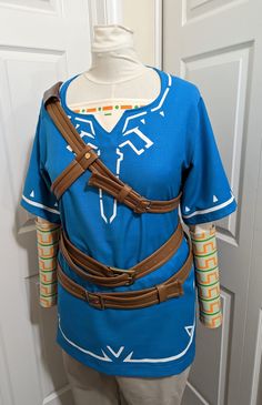 a mannequin wearing a blue shirt and brown leather belted around it's waist