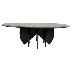 an oval table with two black legs and a marble top, on a white background