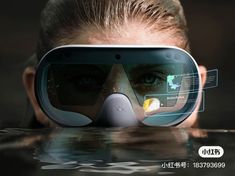 a woman wearing virtual reality goggles floating in the water with her head up and eyes closed