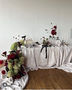 a table with flowers and candles on it