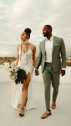 a bride and groom walking together on the roof