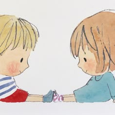 two children are sitting down and touching hands