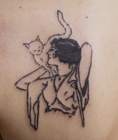 a woman with a cat on her back tattooing it's shoulder and chest